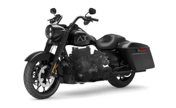 Una moto diesel negra, estilo bagger, con motor expuesto y alforjas.